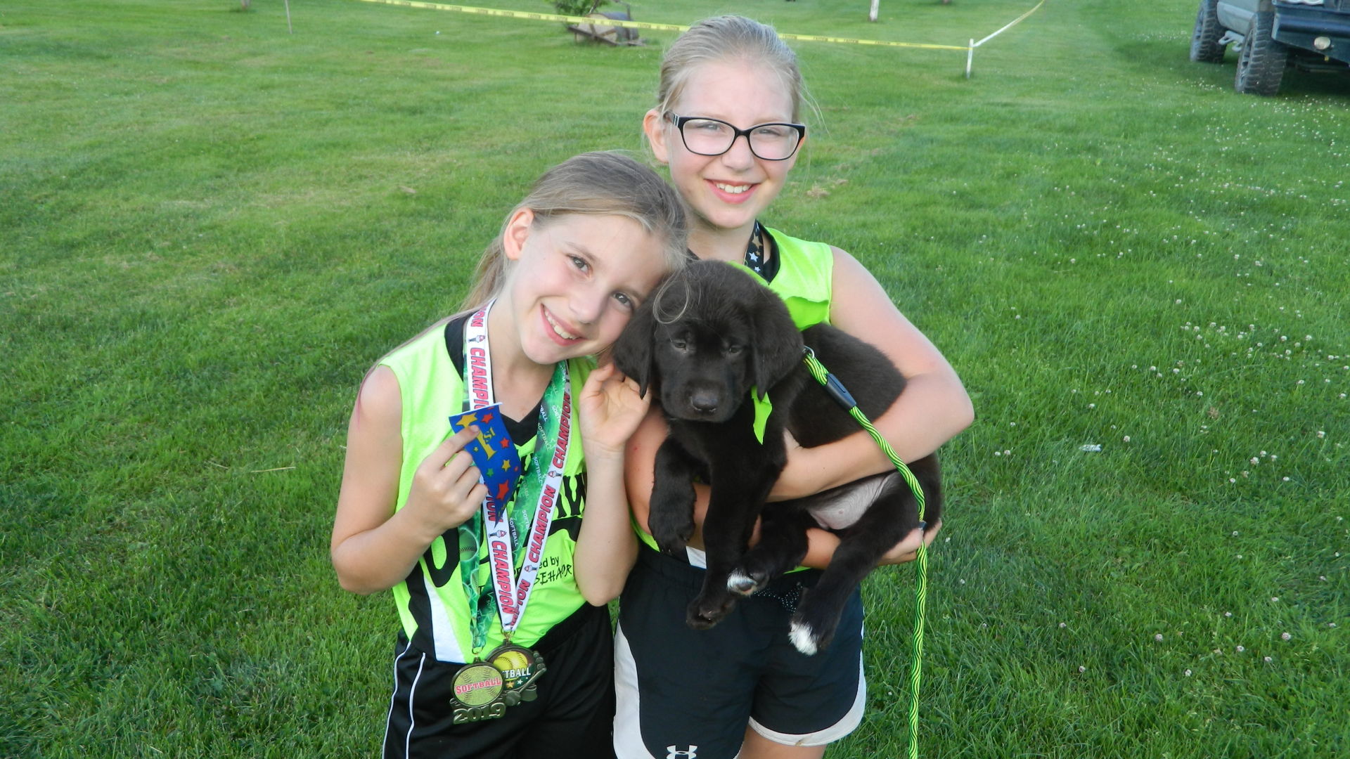 Sisters pose with their pup Ellie